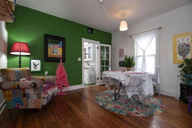 dining space with hardwood / wood-style flooring