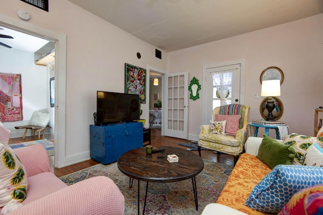 living room featuring hardwood / wood-style flooring and ceiling fan