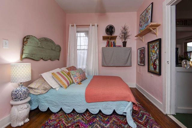 bedroom with dark hardwood / wood-style floors