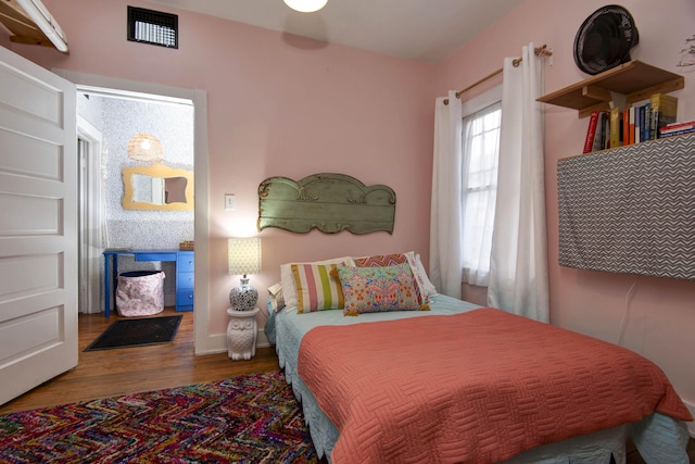 bedroom with hardwood / wood-style flooring