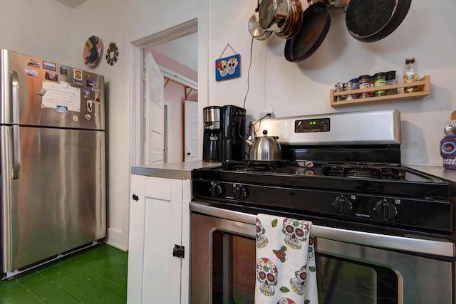 kitchen with white cabinets and appliances with stainless steel finishes