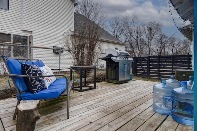 wooden deck featuring area for grilling and central AC unit