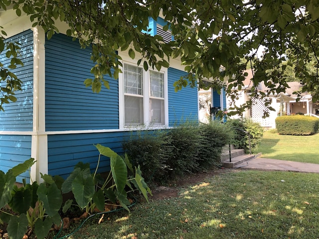 view of home's exterior with a yard