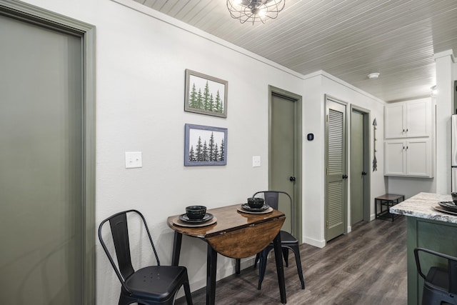 dining space with dark hardwood / wood-style flooring