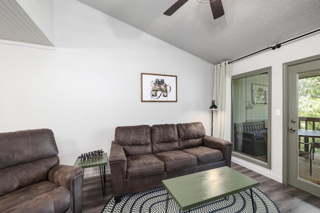 living room featuring ceiling fan, lofted ceiling, dark wood-type flooring, and a textured ceiling