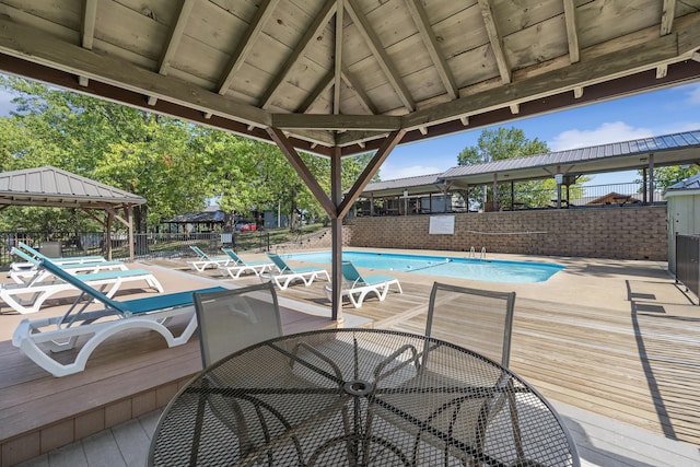 view of pool with a wooden deck and a gazebo