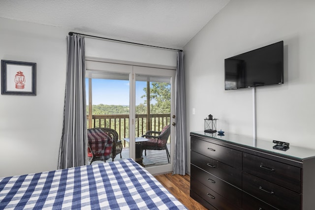 bedroom with access to exterior, a textured ceiling, and light wood-type flooring