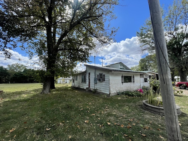 view of side of home with a lawn