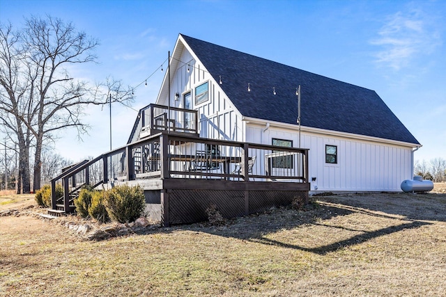 rear view of property featuring a yard and a deck