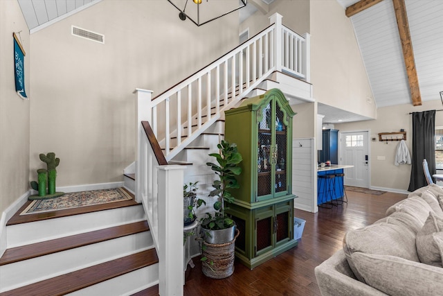 staircase featuring beamed ceiling, wood-type flooring, high vaulted ceiling, and wooden ceiling