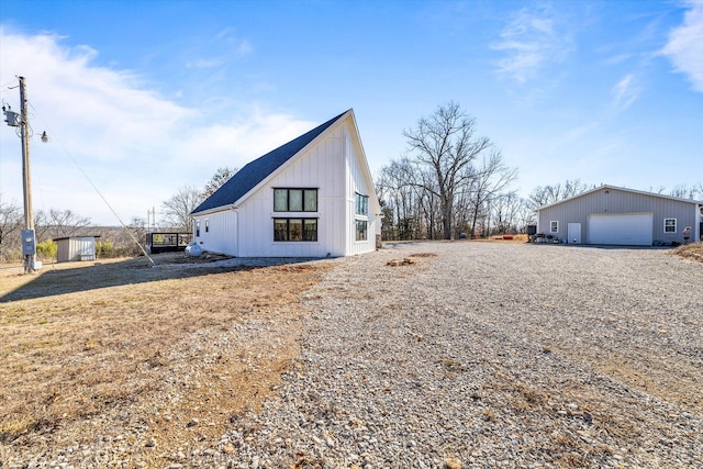 view of front of house with a garage and an outdoor structure