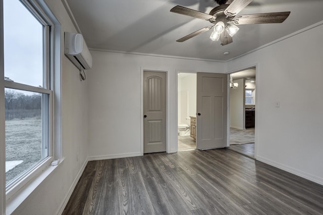 unfurnished bedroom featuring dark hardwood / wood-style floors, connected bathroom, a wall mounted air conditioner, ornamental molding, and ceiling fan