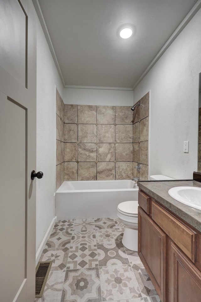 full bathroom featuring vanity, toilet, crown molding, and tiled shower / bath