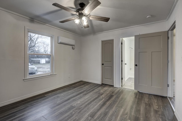 unfurnished bedroom with dark wood-type flooring, connected bathroom, ornamental molding, a wall unit AC, and ceiling fan