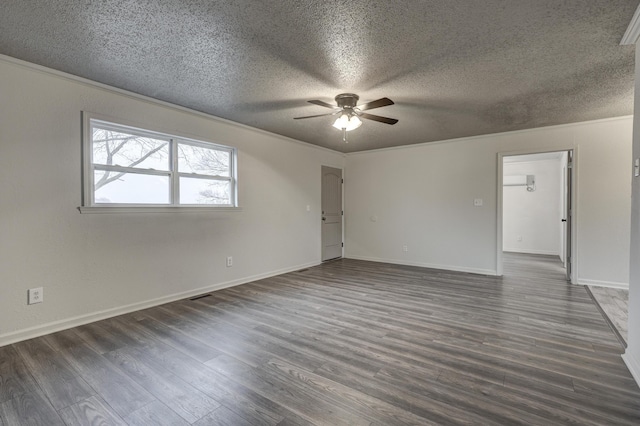 empty room with ornamental molding, dark hardwood / wood-style floors, and a textured ceiling