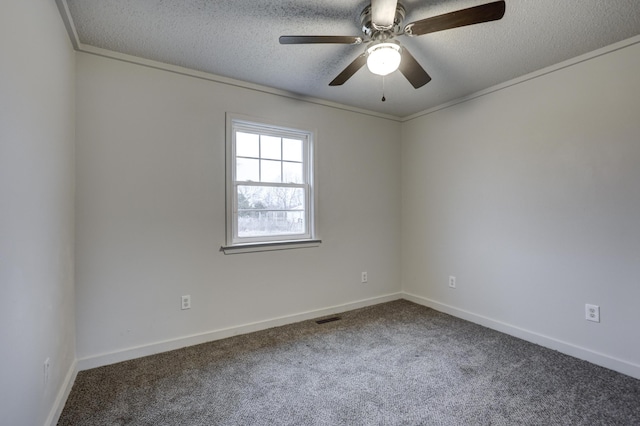 carpeted spare room featuring ceiling fan and a textured ceiling