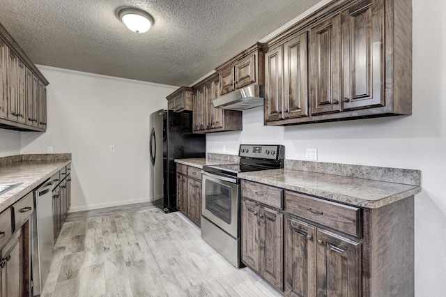 kitchen featuring appliances with stainless steel finishes, dark brown cabinetry, ornamental molding, a textured ceiling, and light wood-type flooring