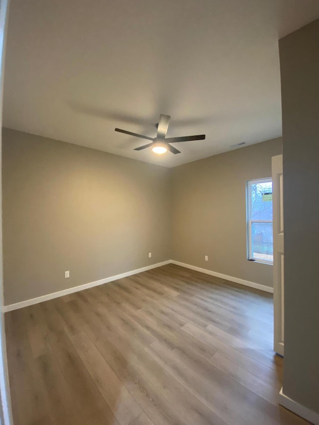 spare room with ceiling fan and light hardwood / wood-style flooring