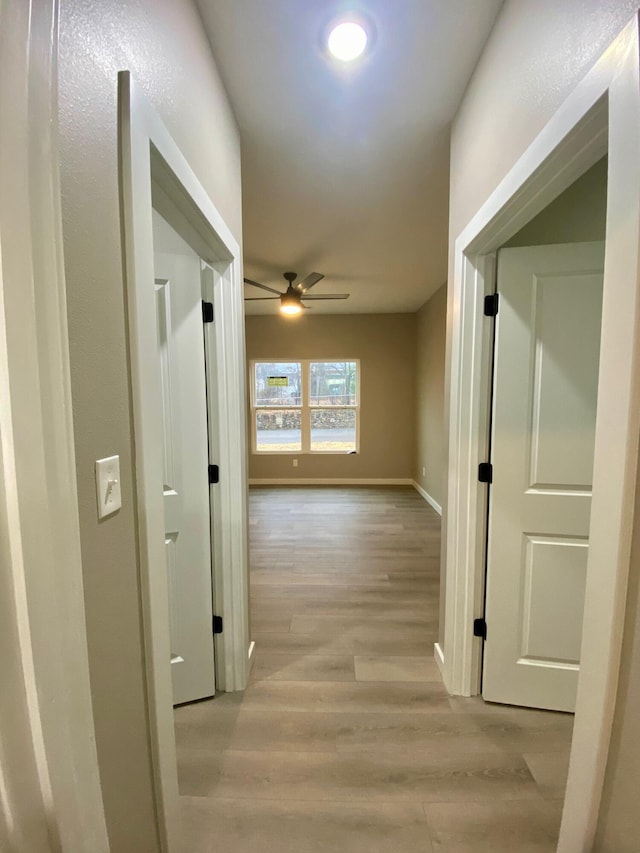 hallway with light wood-type flooring