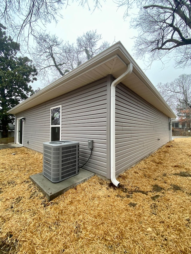 view of side of home featuring central AC