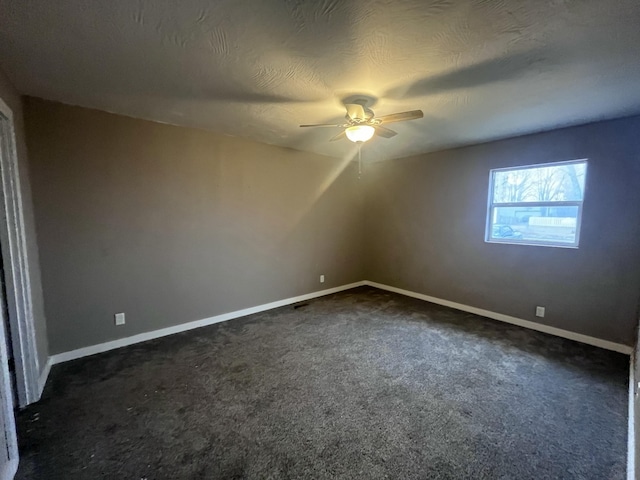 additional living space featuring ceiling fan, a textured ceiling, and dark colored carpet