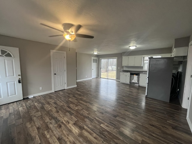 unfurnished living room featuring dark hardwood / wood-style floors, a textured ceiling, and ceiling fan