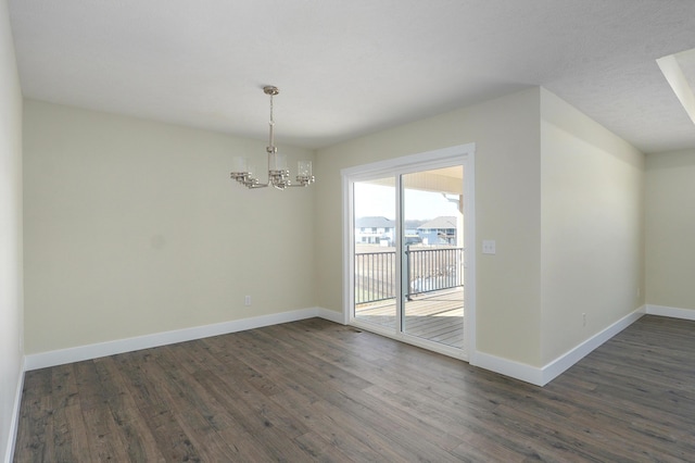 unfurnished dining area featuring dark hardwood / wood-style floors and a chandelier