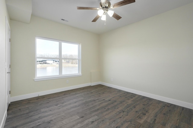 spare room with ceiling fan and dark hardwood / wood-style floors