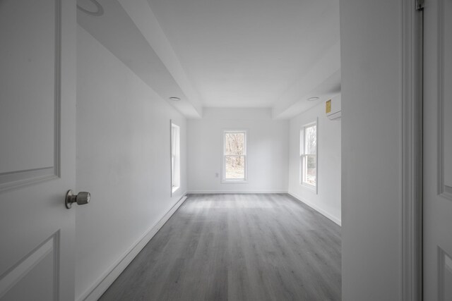 unfurnished room with light hardwood / wood-style flooring and an AC wall unit