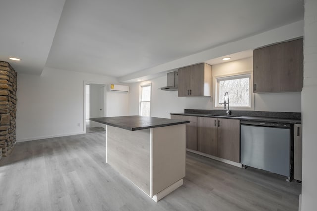 kitchen with sink, light wood-type flooring, stainless steel dishwasher, a kitchen island, and a wall unit AC