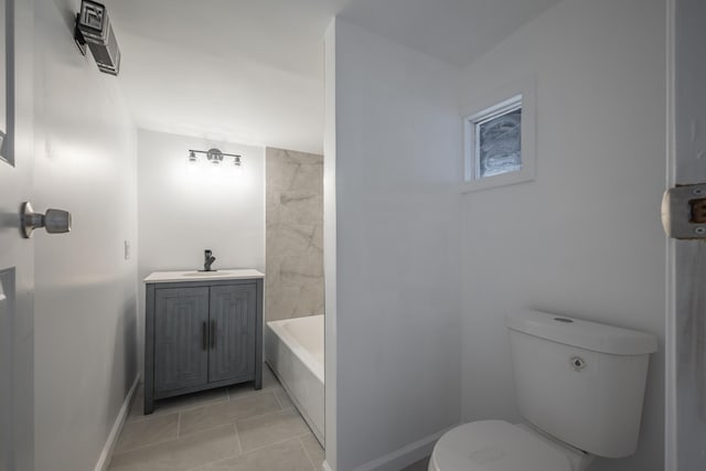 bathroom with sink, a bath, and toilet