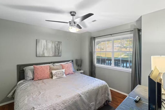 bedroom with dark wood-type flooring and ceiling fan