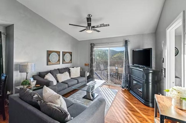 living room featuring ceiling fan, lofted ceiling, and hardwood / wood-style floors