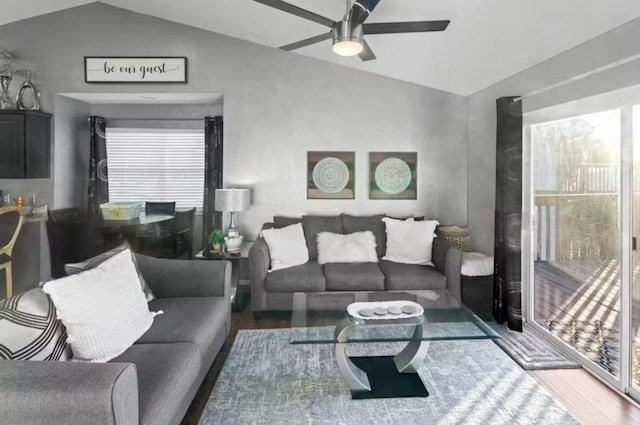 living room with lofted ceiling, hardwood / wood-style floors, and ceiling fan