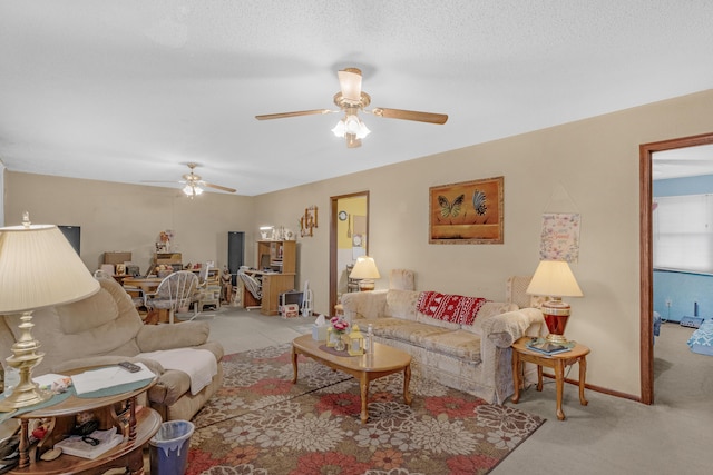 carpeted living room with ceiling fan and a textured ceiling