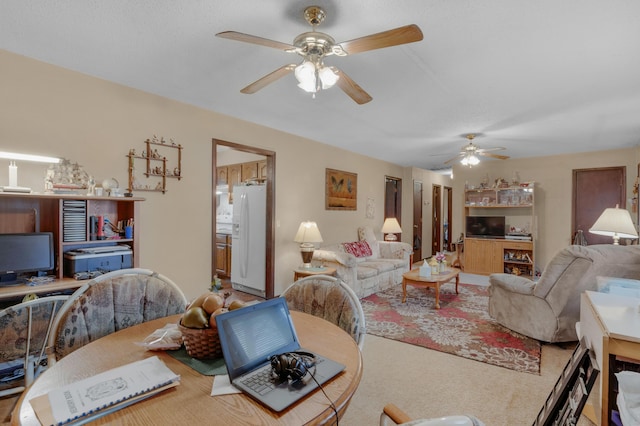 living room with ceiling fan and carpet flooring