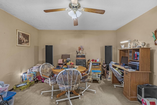 carpeted home office featuring ceiling fan and a textured ceiling