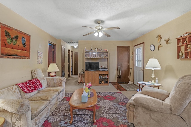 living room with ceiling fan and a textured ceiling