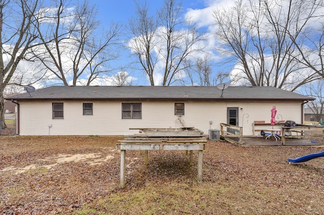 rear view of house with central AC unit and a deck