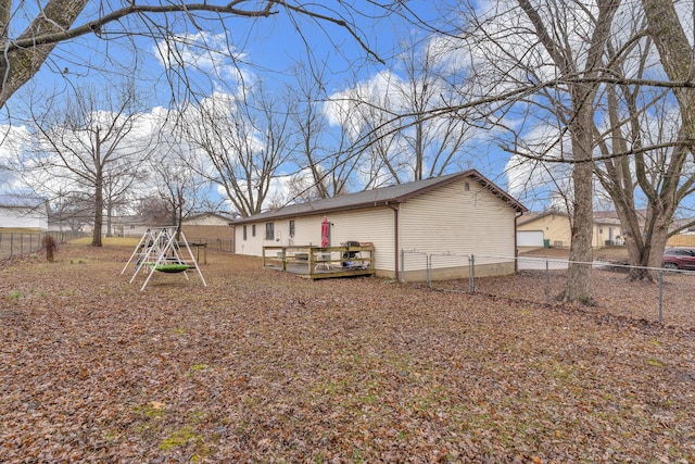 view of yard featuring a deck and a playground