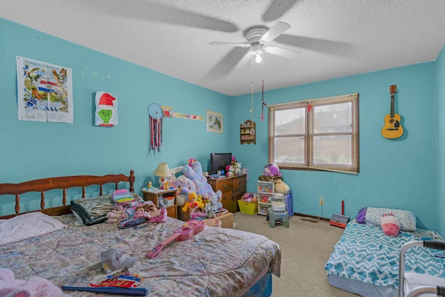 bedroom featuring ceiling fan, carpet floors, and a textured ceiling