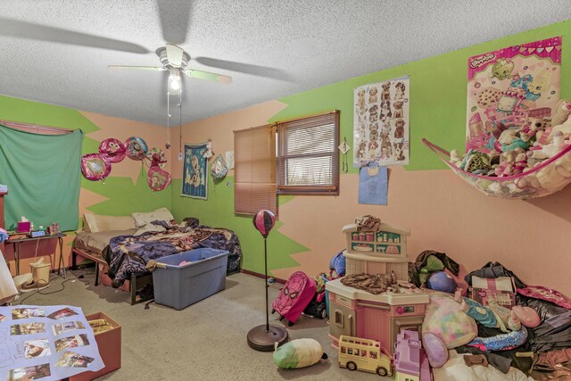 carpeted bedroom with ceiling fan and a textured ceiling