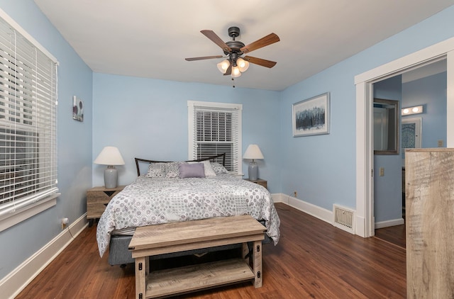 bedroom with ceiling fan and dark hardwood / wood-style floors