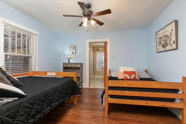 bedroom with ceiling fan and dark hardwood / wood-style flooring