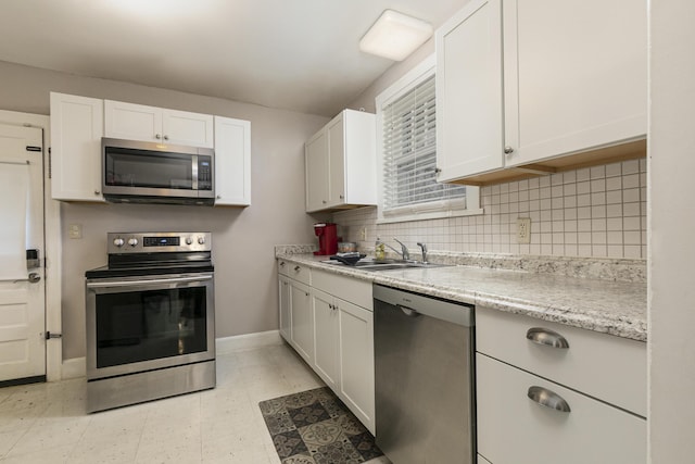 kitchen with appliances with stainless steel finishes, sink, and white cabinets