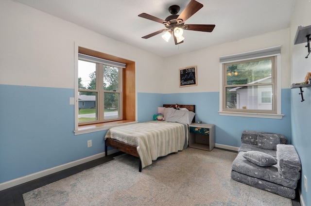 bedroom featuring multiple windows and ceiling fan