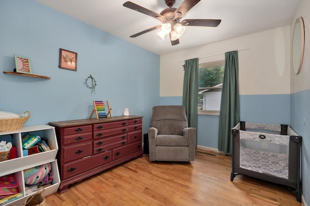 sitting room featuring ceiling fan and light hardwood / wood-style floors