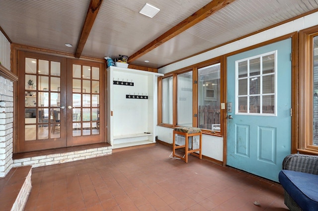 doorway with french doors and beamed ceiling