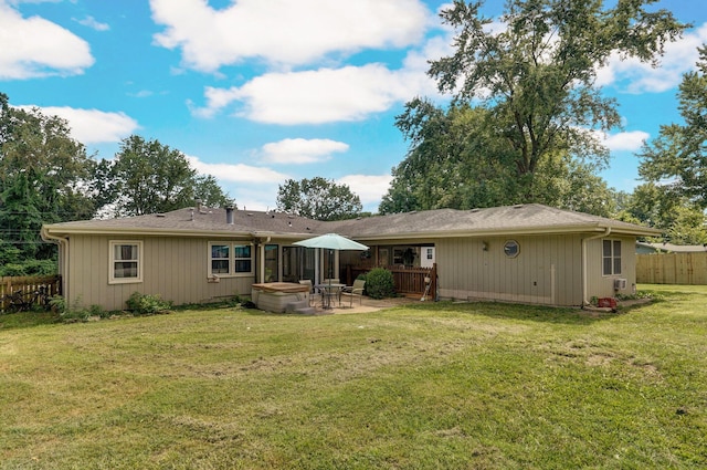 back of property with a patio area and a lawn