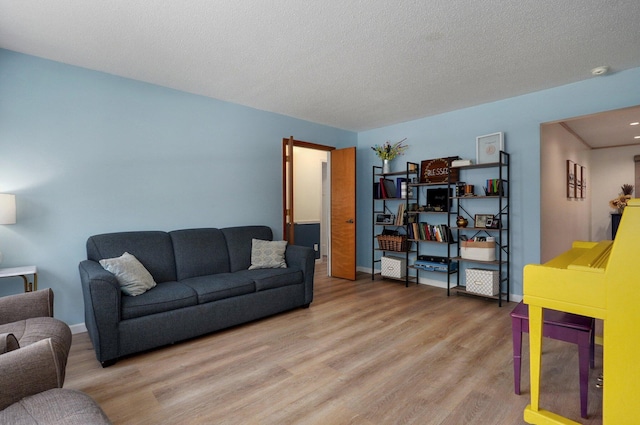 living room featuring wood-type flooring and a textured ceiling